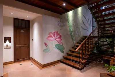 a staircase in a house with a painting on the wall at Ariyasom Villa in Bangkok