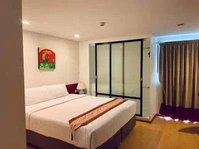 a bedroom with a large bed and a window at I Residence Hotel Sathorn in Bangkok