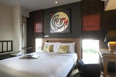 a bedroom with a large white bed and a desk at Sleep Withinn in Bangkok