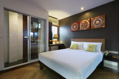 a bedroom with a large white bed and a shower at Sleep Withinn in Bangkok