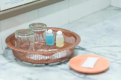 a basket with bottles and glasses on a counter at Bangkok Loft at Nana Station in Bangkok