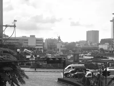 a black and white photo of a city with cars parked at Inn Trog And Inn Soi in Bangkok