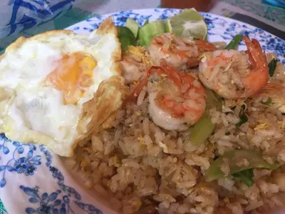 a plate of food with shrimp and eggs and rice at Inn Trog And Inn Soi in Bangkok