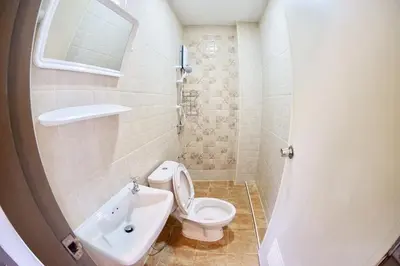 a bathroom with a white toilet and a sink at Inn Trog And Inn Soi in Bangkok