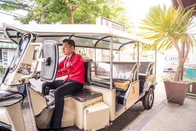 a man sitting in the back of a golf cart at Vabua Asotel Bangkok in Bangkok