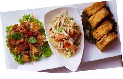 a plate of food with noodles and salad and tofu at Vabua Asotel Bangkok in Bangkok