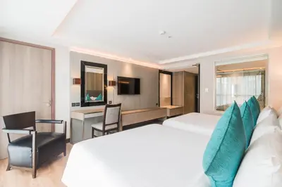 a hotel room with a bed and a desk at Citrus Suites Sukhumvit 6 by Compass Hospitality in Bangkok