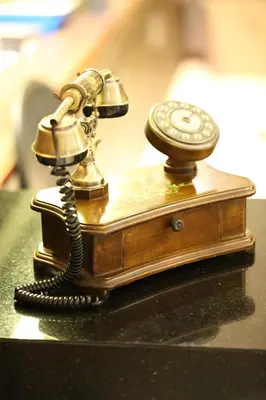 a telephone sitting on top of a table at The Dawin Hotel in Bangkok