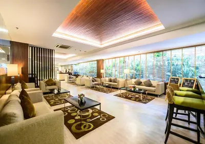 a large living room with couches and tables and windows at Lohas Residences Sukhumvit 2 in Bangkok