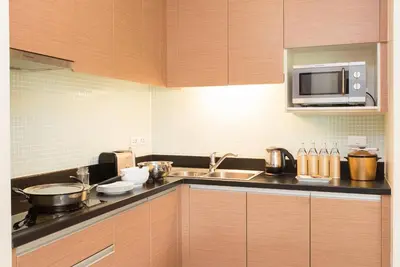 a kitchen with a sink and a microwave at Lohas Residences Sukhumvit 2 in Bangkok