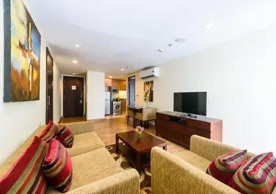 a living room with two couches and a flat screen tv at Lohas Residences Sukhumvit 2 in Bangkok