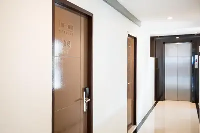 a door with a sign on it in a hallway at Twentynine KV Apartel in Nonthaburi