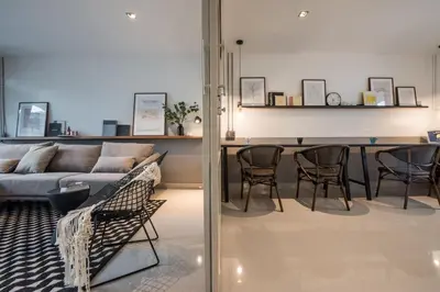 a living room with a couch and a table at Aridom Designer Loft House in Bangkok