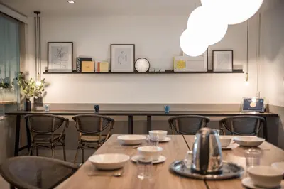 a dining room with a table and chairs at Aridom Designer Loft House in Bangkok