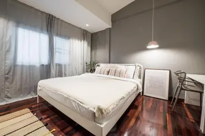 a bedroom with a white bed and a window at Aridom Designer Loft House in Bangkok