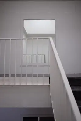 a white staircase with a window in a building at Haus Sathorn 21 Bed and Breakfast in Bangkok