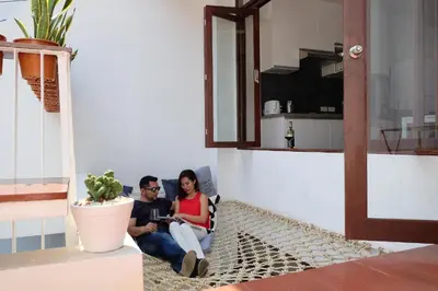 a man and woman sitting on the floor in a living room at Haus Sathorn 21 Bed and Breakfast in Bangkok