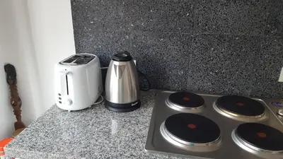 a kitchen counter with a toaster and a coffee maker at Haus Sathorn 21 Bed and Breakfast in Bangkok