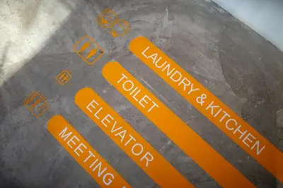 a close up of a floor with orange stickers on it at Yaks House Hostel in Bangkok