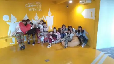 a group of women sitting in a room at Yaks House Hostel in Bangkok