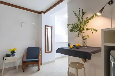 a dining room with a blue table and a chair at Collection O Howard Square Boutique Hotel in Bangkok