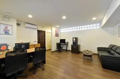 an office with a couch and a table and chairs at Studio Residence Sukhumvit 71 in Bangkok
