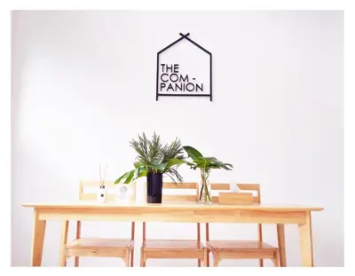 a dining room table with chairs and a sign that reads the room random at The Companion in Bangkok