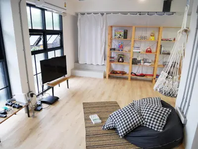 a living room with a hammock in the middle of it at The Companion in Bangkok