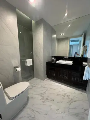a bathroom with a toilet and a shower and a sink at Rongratana Executive Residence Bangkok in Bangkok