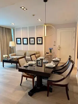 a living room with a table and chairs and a couch at Rongratana Executive Residence Bangkok in Bangkok