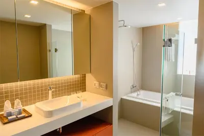 a bathroom with a sink and a shower at Oakwood Residence Sukhumvit Thonglor Bangkok in Bangkok