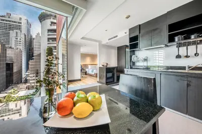 a kitchen with a plate of fruit on a counter at Golden Tulip Mandison Suites in Bangkok
