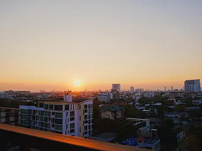 a view of a city at sunset from a building at BoonRumpa Accommodation in Bangkok