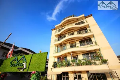 a tall building with balconies and plants on it at Baanthanam Nont in Nonthaburi