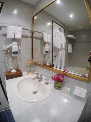 a bathroom with a sink and a mirror at City Lodge Bangkok in Bangkok