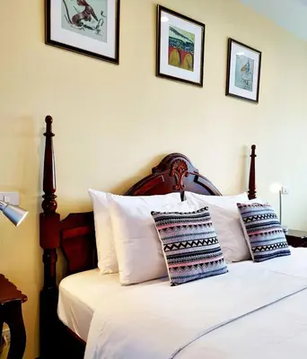 a bedroom with a bed with white sheets and pillows at Focal Local Bed & Breakfast in Bangkok