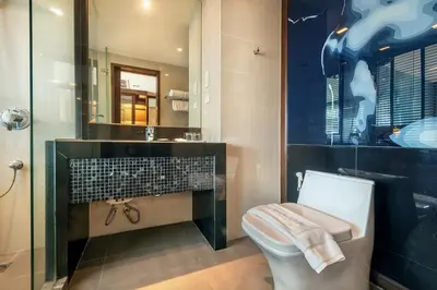 a bathroom with a toilet and a sink at M2 de Bangkok Hotel in Bangkok