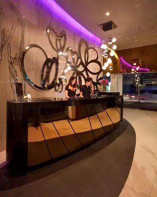a group of people sitting at a counter in a room at M2 de Bangkok Hotel in Bangkok