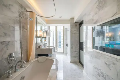 a large bathroom with a tub and a sink at Akara Hotel in Bangkok