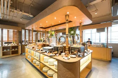 a kitchen with a counter with dishes on it at Akara Hotel in Bangkok