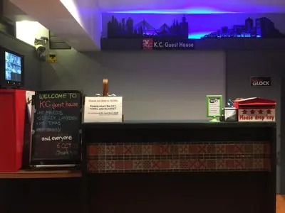 a restaurant with a counter with signs on it at KC guest house in Bangkok