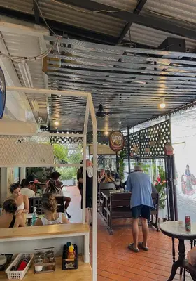 a group of people eating at a restaurant at KC guest house in Bangkok