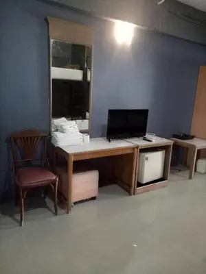 an office with a desk with a computer and a chair at Tongpoon Hotel in Bangkok