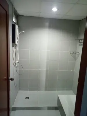 a bathroom with a shower stall with a shower at Tongpoon Hotel in Bangkok