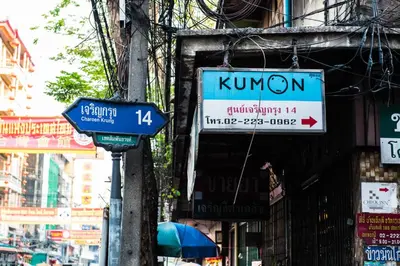 a sign for a korean store on a city street at Arawana Express Chinatown in Bangkok