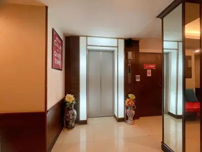 a hallway with two vases with flowers in it at Arawana Express Chinatown in Bangkok