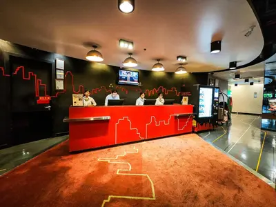 a restaurant with a red counter with drawings on the floor at Galleria 10 Hotel Bangkok in Bangkok
