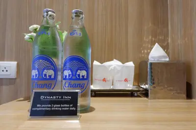 two bottles of drinking water sitting on a table at Dynasty Inn in Bangkok