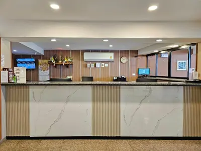 a large lobby with a large marble counter top at Dynasty Inn in Bangkok