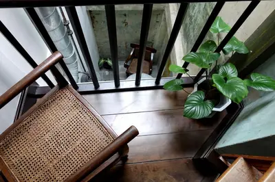 a balcony with a chair and a plant at 1905 Heritage Corner in Bangkok